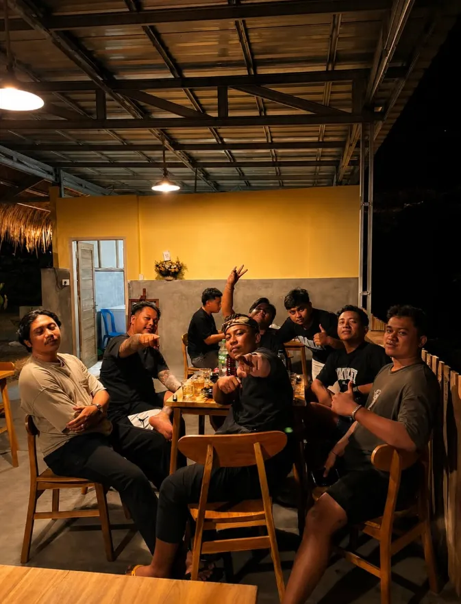 Guests around a table against a yellow wall